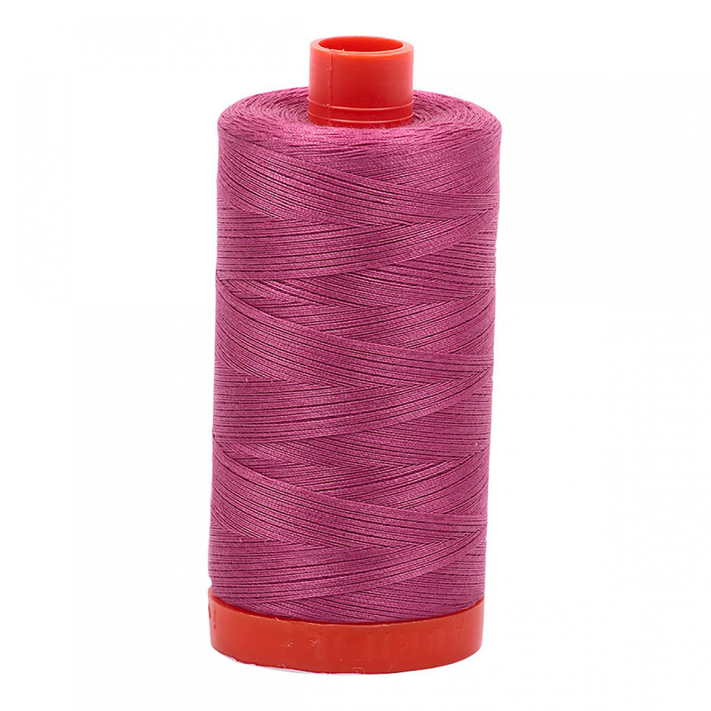 A spool of Aurifil 2450 - Rose thread on a white background