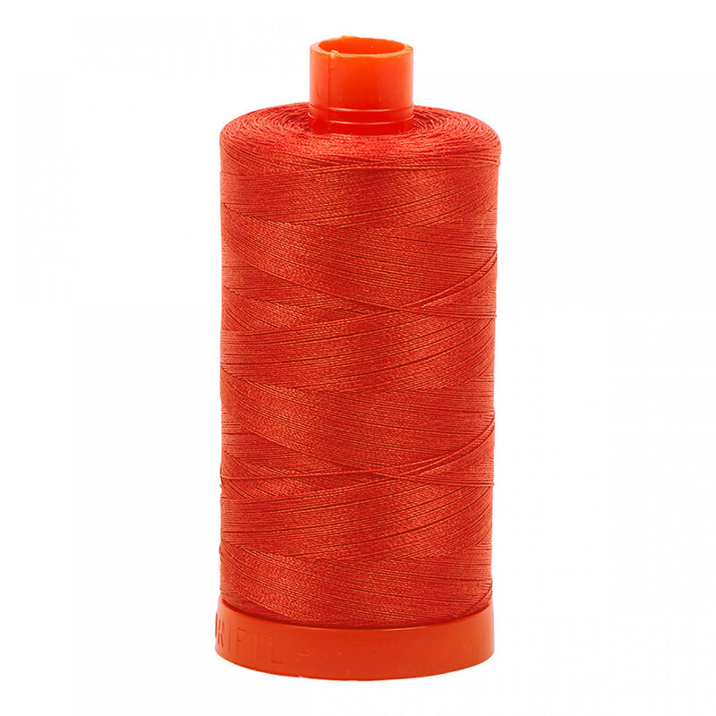 A spool of Aurifil 2245 - Red Orange thread on a white background