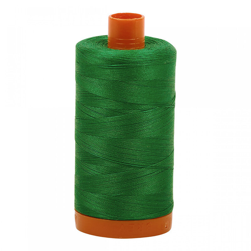 A spool of Aurifil 2870 - Green thread on a white background