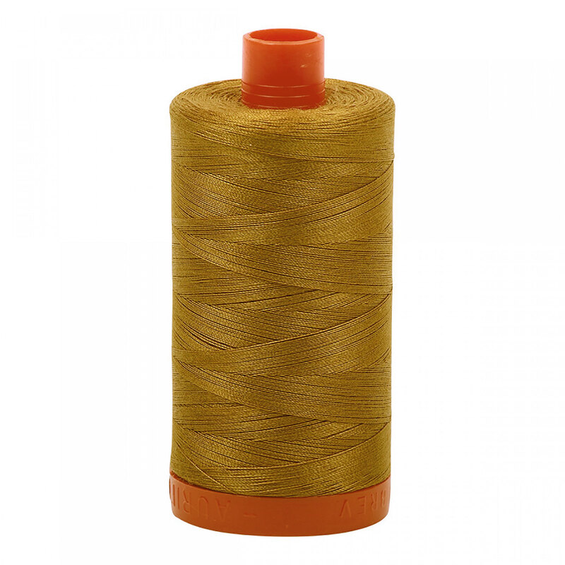 A spool of Aurifil 2975 - Brass thread on a white background