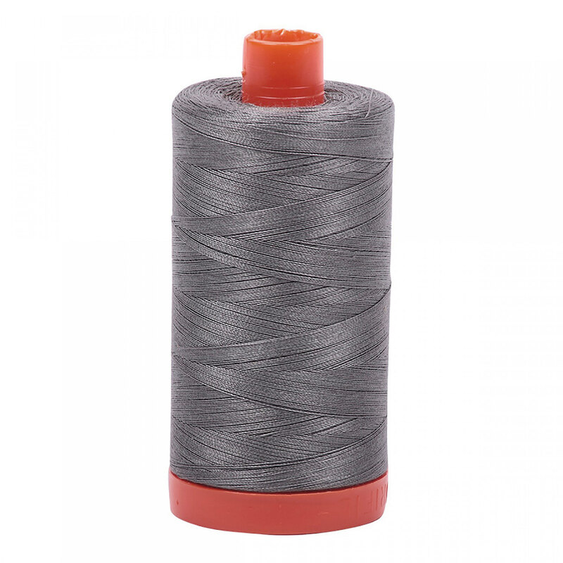 A spool of Aurifil 5004 - Grey Smoke thread on a white background