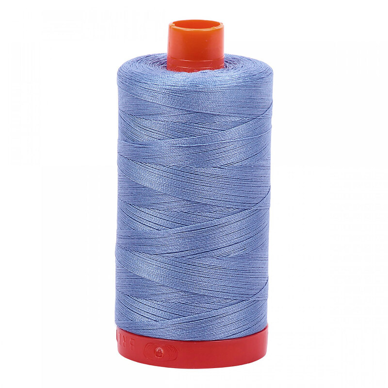 A spool of Aurifil 2720 - Light Delft Blue thread on a white background