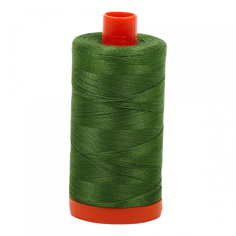 A spool of Aurifil 2890 - Very Dark Grass Green thread on a white background