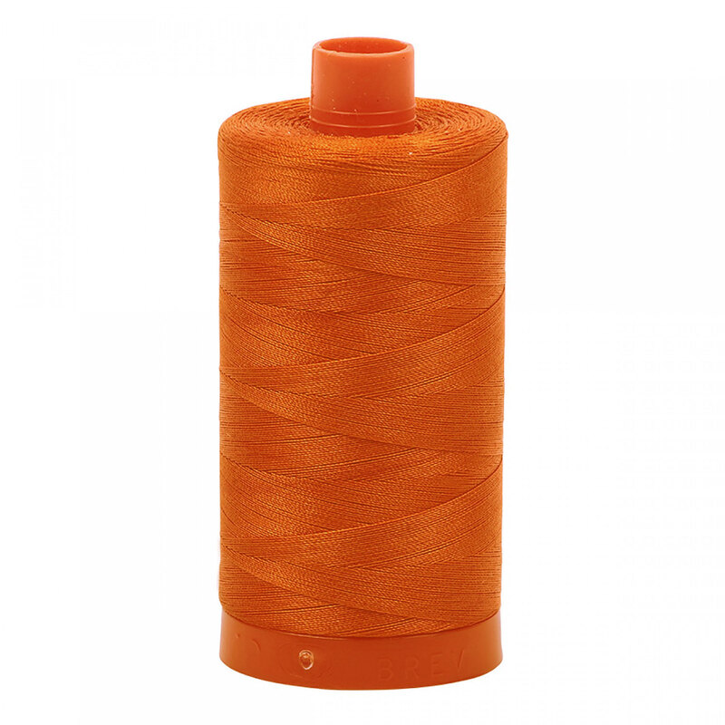 A spool of Aurifil 2235 - Orange thread on a white background