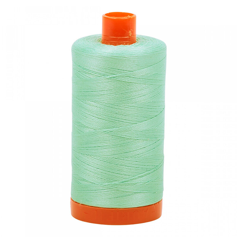A spool of Aurifil 2830 - Mint thread on a white background