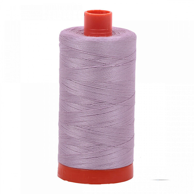 A spool of Aurifil 2562 - Lilac thread on a white background