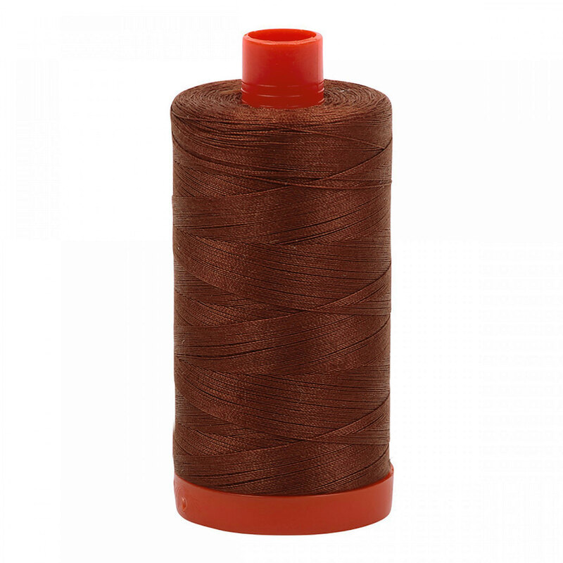 A spool of Aurifil 4012 - Copper Brown thread on a white background