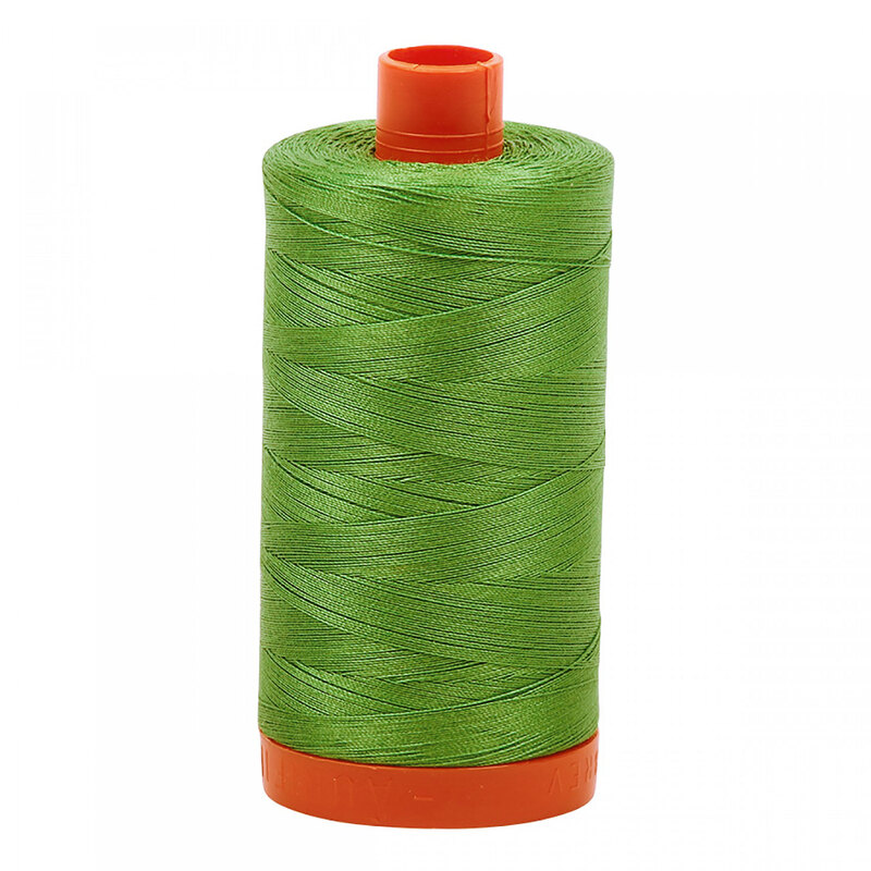 A spool of Aurifil 2884 - Green Yellow thread on a white background