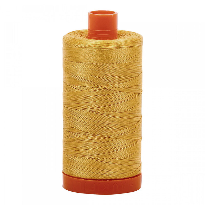 A spool of Aurifil 2134 - Spun Gold thread on a white background