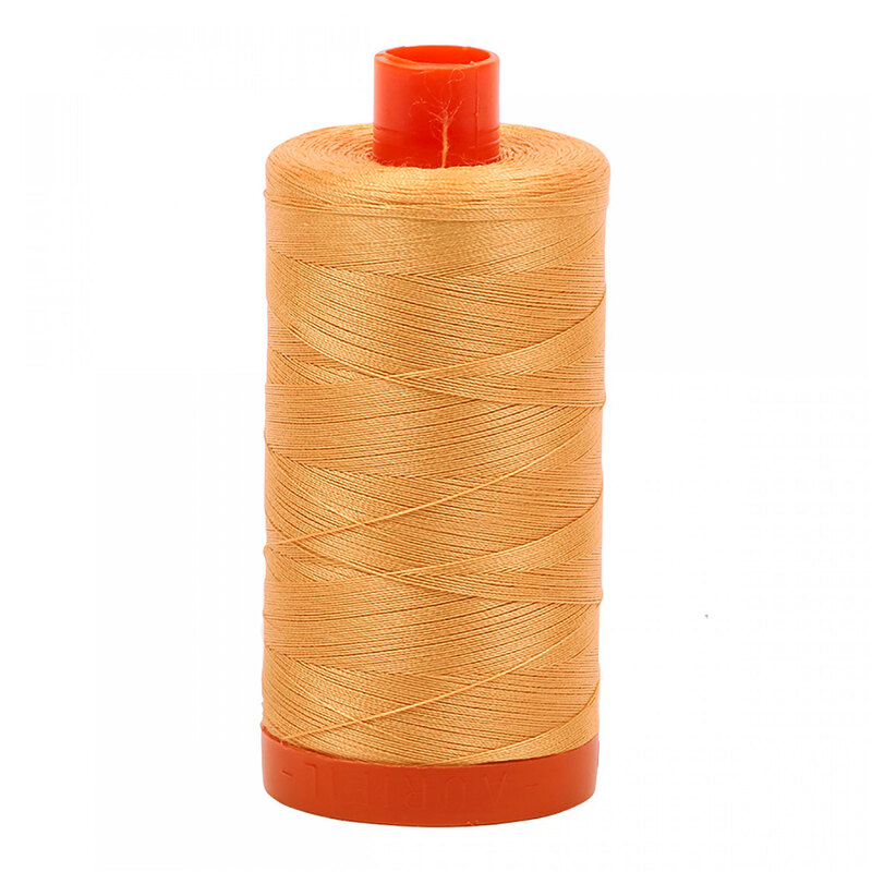 A spool of Aurifil 2214 - Golden Honey thread on a white background