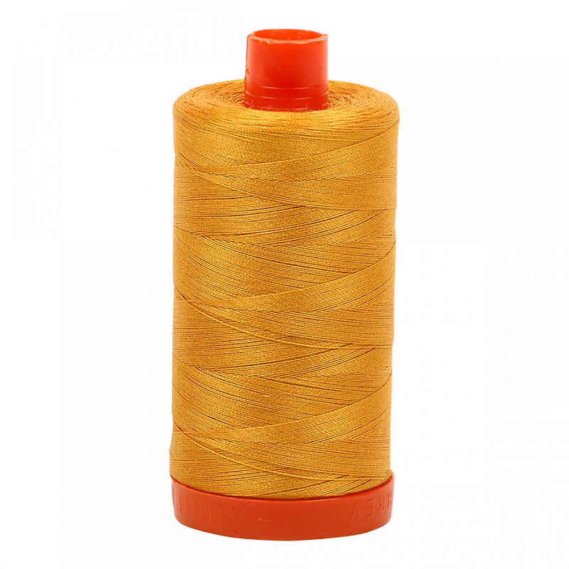 A spool of Aurifil 2140 - Orange Mustard thread on a white background