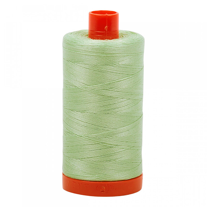 A spool of Aurifil 2880 - Pale Green thread on a white background