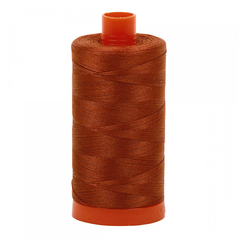 A spool of Aurifil 2350 - Copper thread on a white background