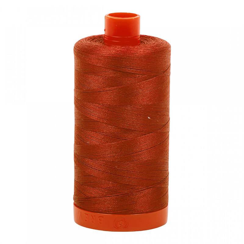 A spool of Aurifil 2395 -Pumpkin Spice thread on a white background