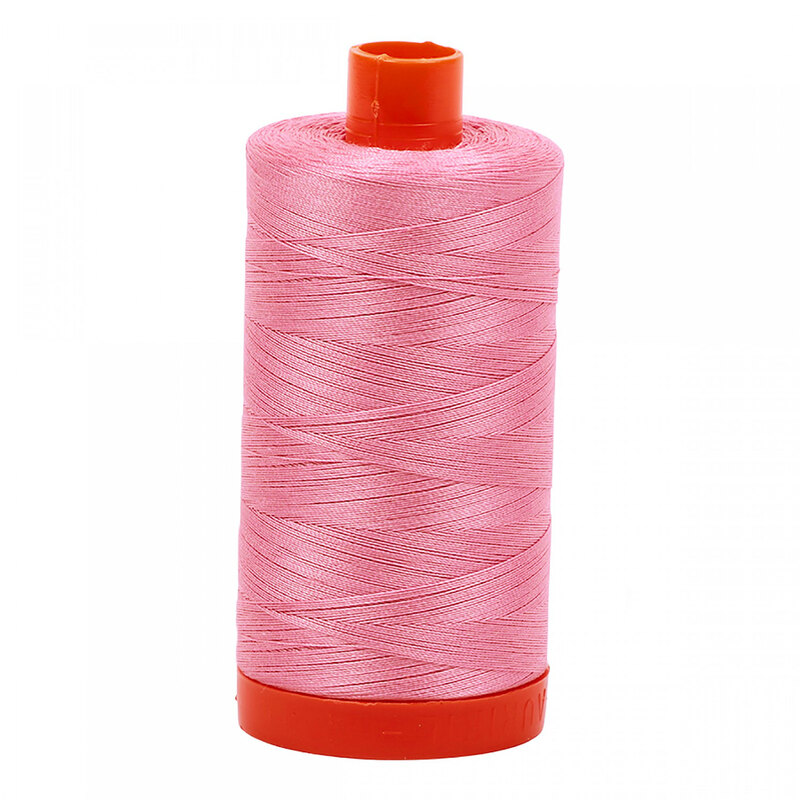 A spool of Aurifil 2430 -Antique Rose thread on a white background