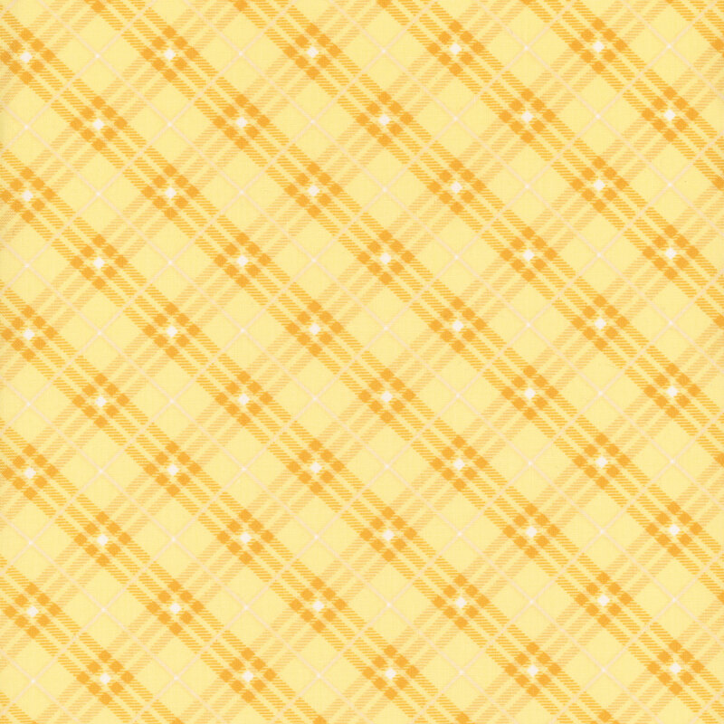 yellow plaid fabric with white stripes and diamonds