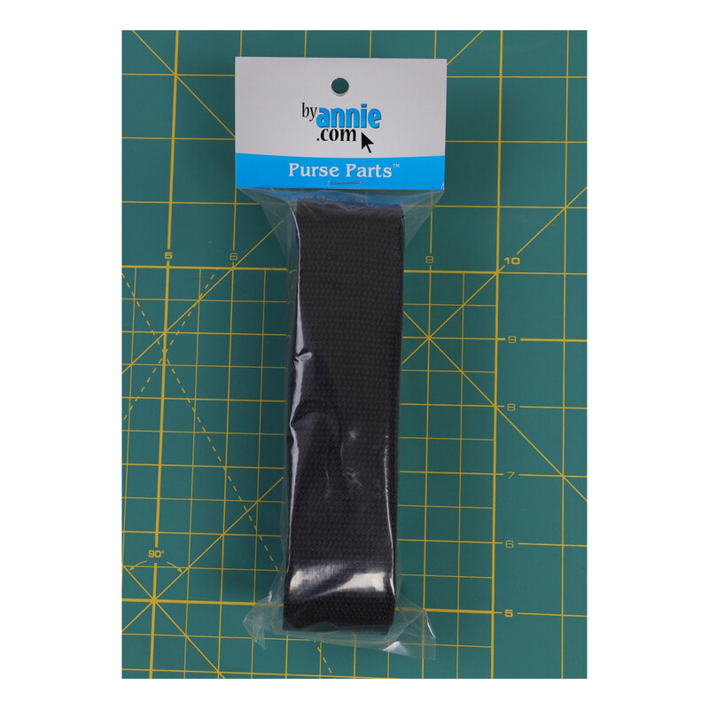 Photo of polypro black bag strapping folded inside a plastic bag packaging resting on a green crafting mat