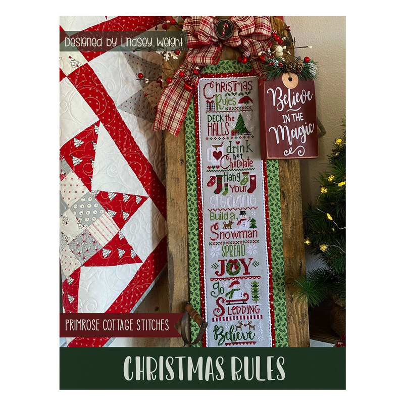 The front of the Christmas Rules Cross Stitch pattern by Primrose Cottage showing the finished project with Christmas decor.