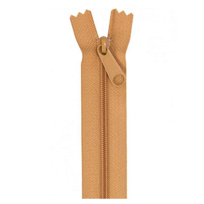 Photo of a light brown zipper isolated on a white background