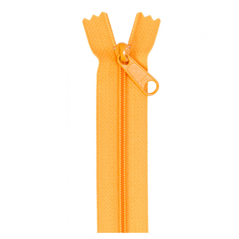 Photo of a yellow orange zipper isolated on a white background