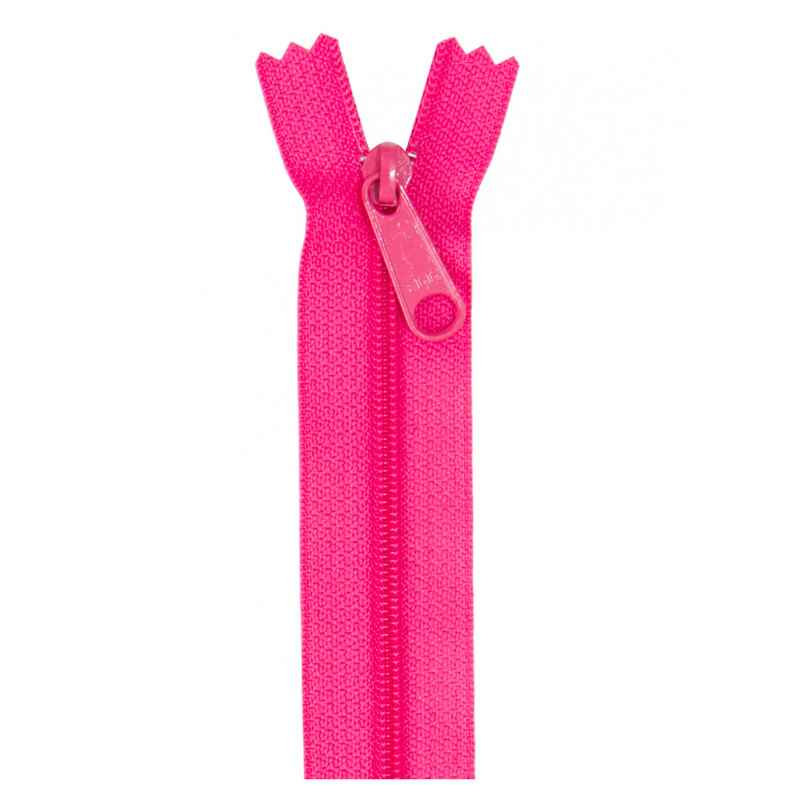 Photo of a hot pink zipper isolated on a white background