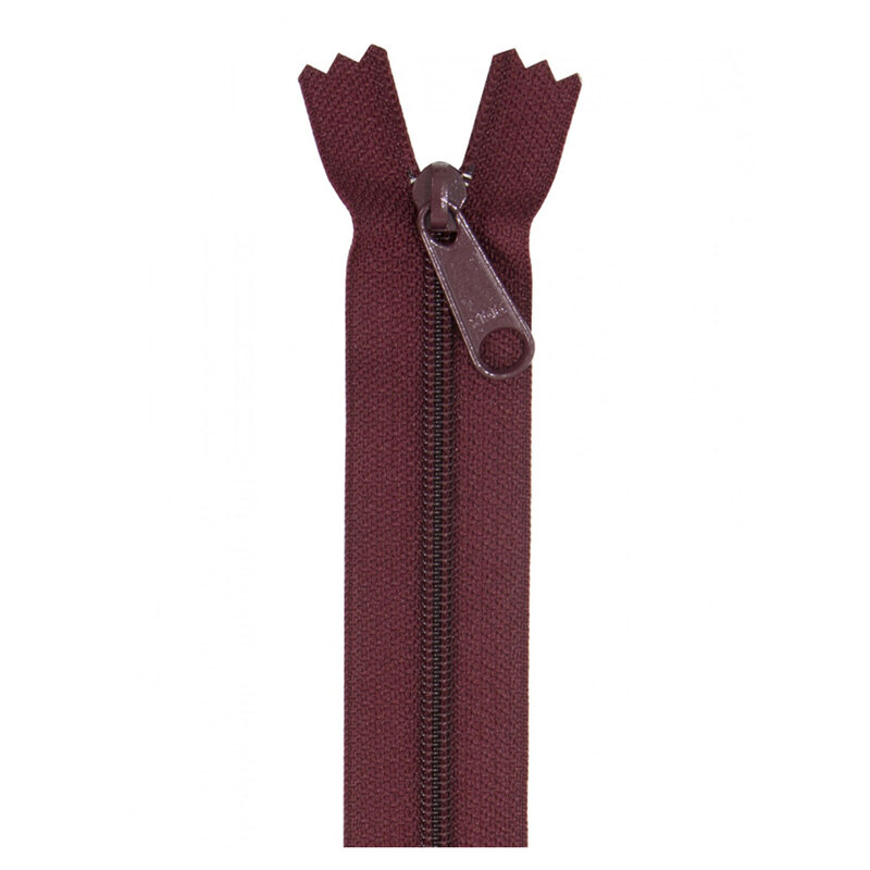 Photo of a dark maroon zipper isolated on a white background