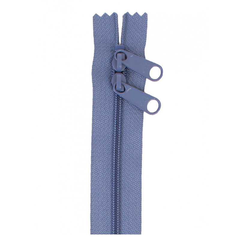 Photo of a dusty blue zipper with two pull tabs isolated on a white background