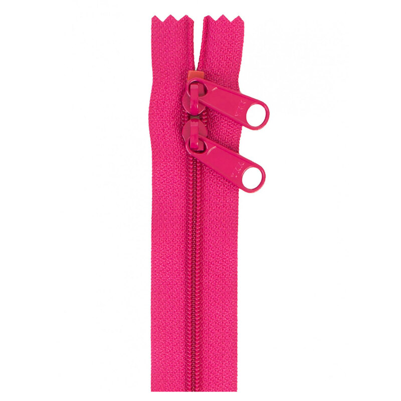 Photo of a bright pink zipper with two pull tabs isolated on a white background