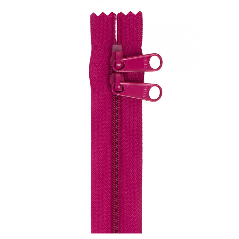 Photo of a bright purple/pink zipper with two pull tabs isolated on a white background