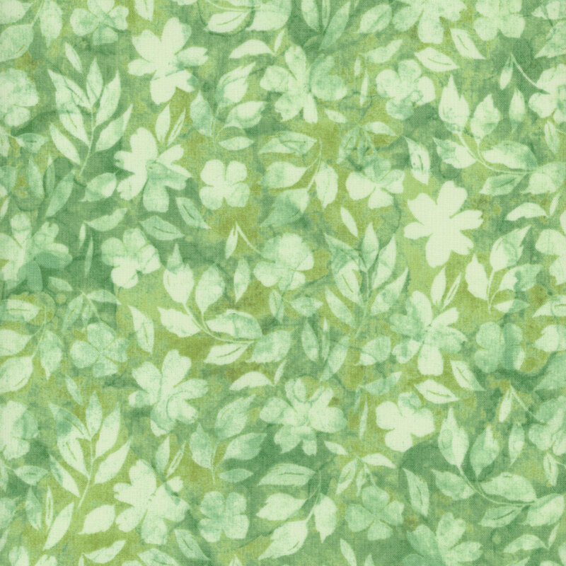 Tonal green fabric with light green leaves and florals against a mottled background
