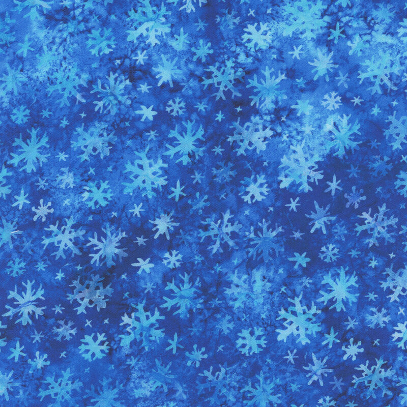 Ice blue tossed snowflakes on a deep true blue background