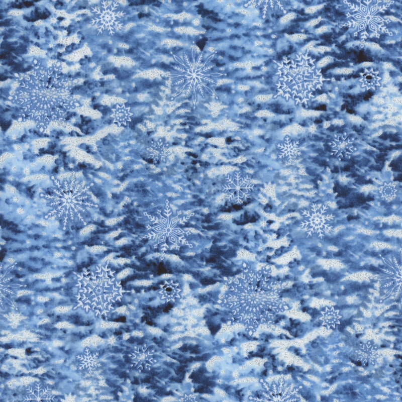 A dense forest of dark blue conifer trees, blanketed in heavy snow and tossed snowflakes throughout