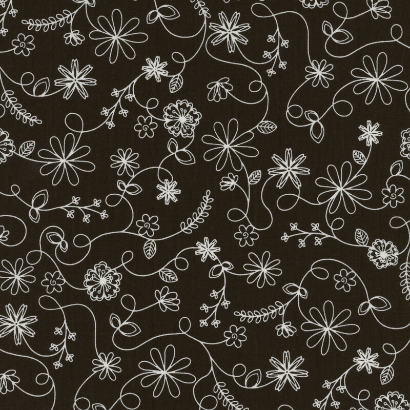 black fabric featuring a swirling vine floral pattern in white