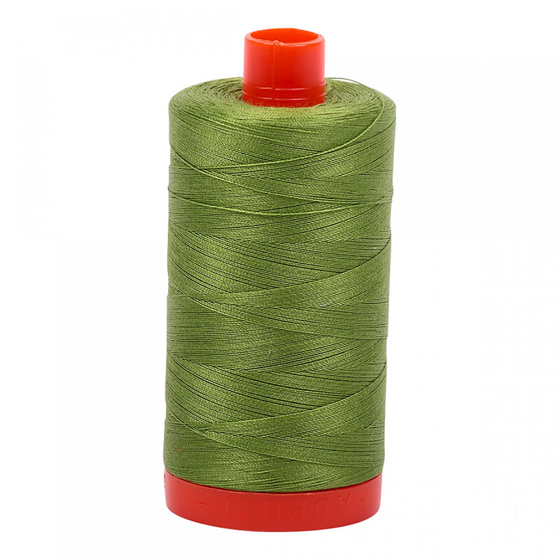 A spool of Aurifil 2888 - Fern Green thread in a leaf green tone on a bright orange spool, a white background