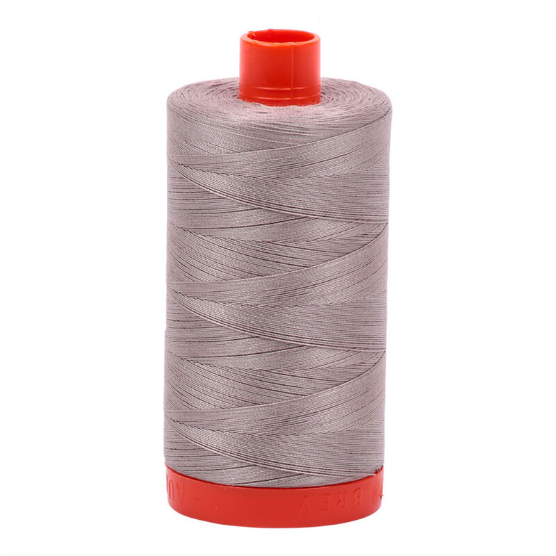 A spool of Aurifil 6730 - Steampunk thread, steely grey overtones with lilac undertones on a bright orange spool, against a white background