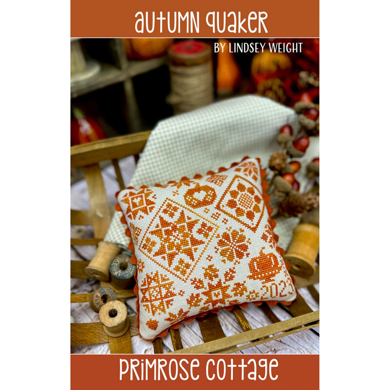 Front of the Autumn Quaker cross stitch pattern, showcasing the completed pumpkin and leaves quaker pattern on a decorate pillow