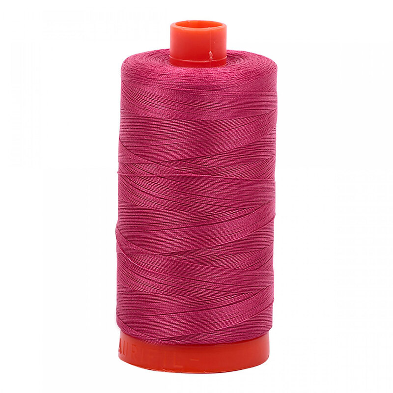 A spool of Aurifil 2455 -Medium Carmine Red thread on a white background, tones of deep candy cherry pink, warm blush and fuschia