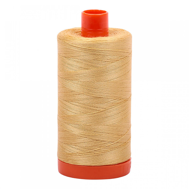 A spool of Aurifil 5001 - Ocher Yellow thread on a white background, notes of buttery yellow, pale flaxen gold, tan like straw