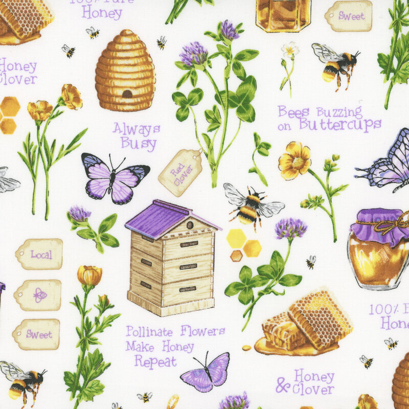 white fabric featuring scattered flowers, butterflies, bees, beehives, and honey, with bee and honey themed sayings interspersed throughout