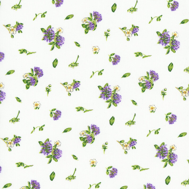white fabric featuring scattered leaves, white flowers, and clover flowers