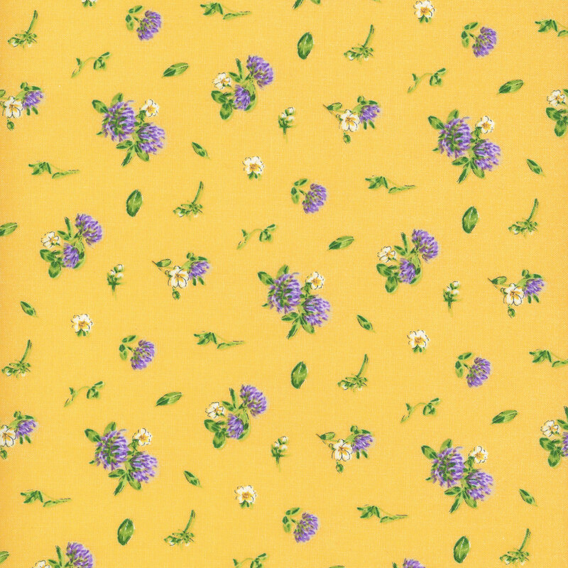 yellow fabric featuring scattered leaves, white flowers, and clover flowers