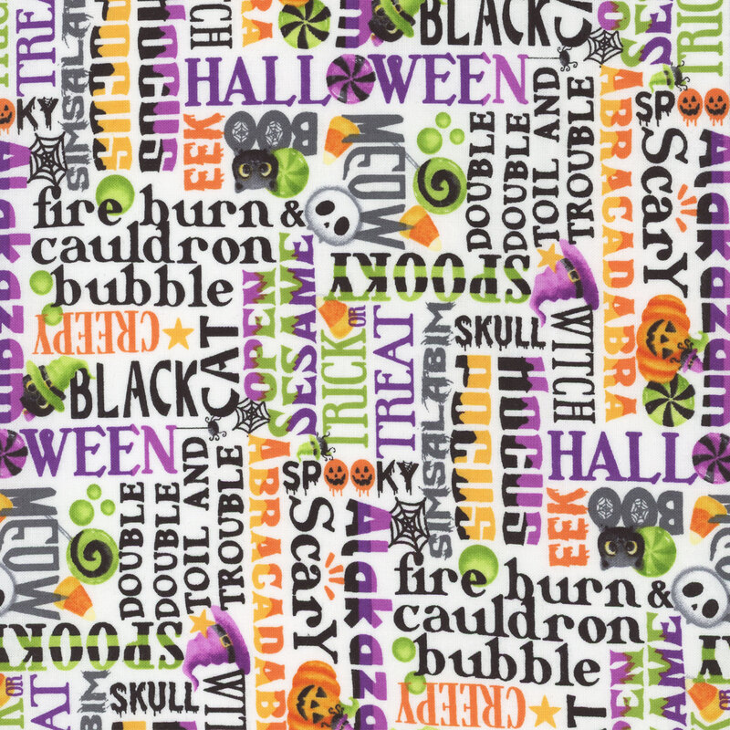 white fabric featuring a packed design of various Halloween sayings, such as 