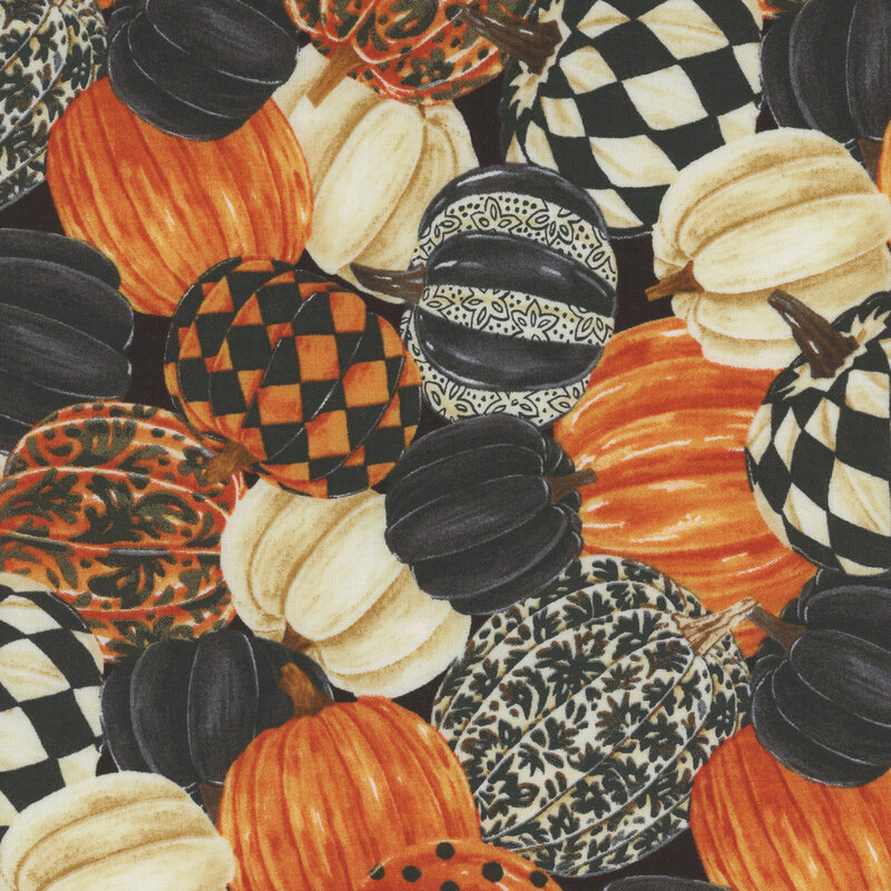 fabric featuring orange, white, and black pumpkins packed together, with some of the pumpkins decorated with various patterns