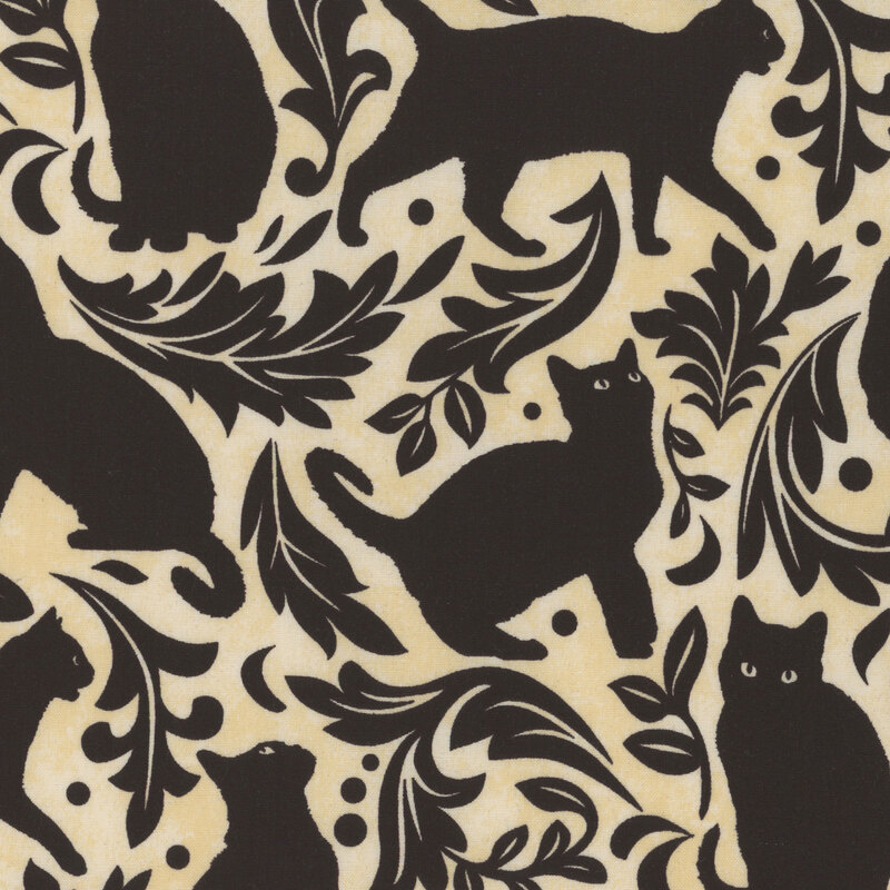 gorgeous cream fabric featuring black silhouettes of cats with black leaves and filigree scattered between