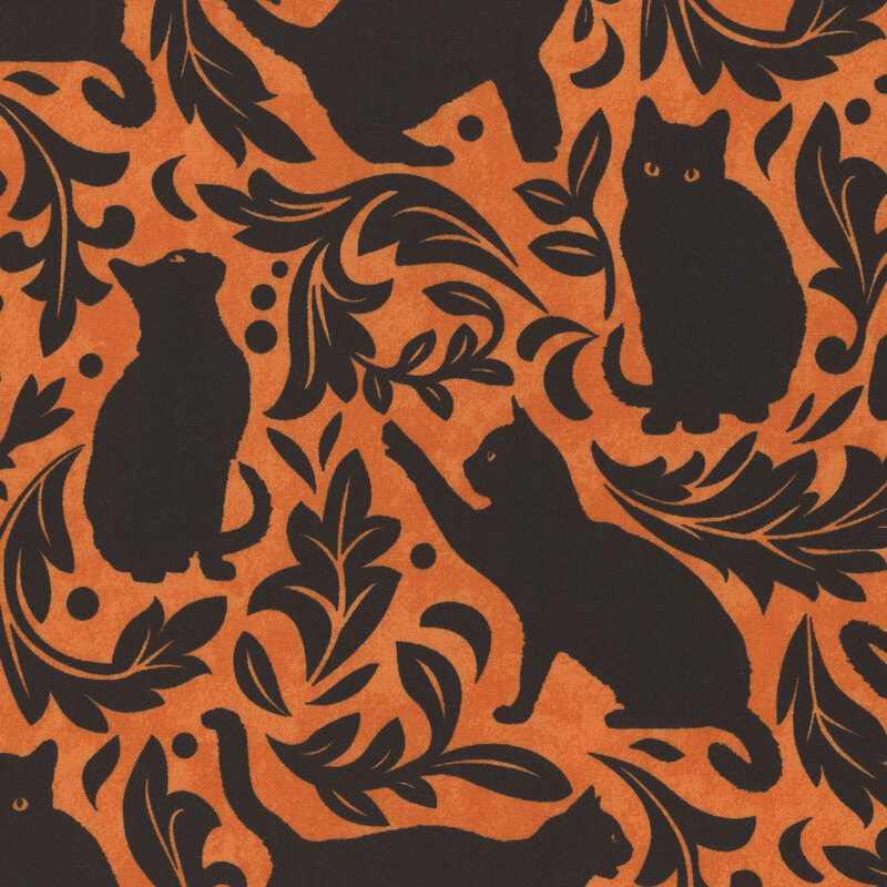 gorgeous orange fabric featuring black silhouettes of cats with black leaves and filigree scattered between