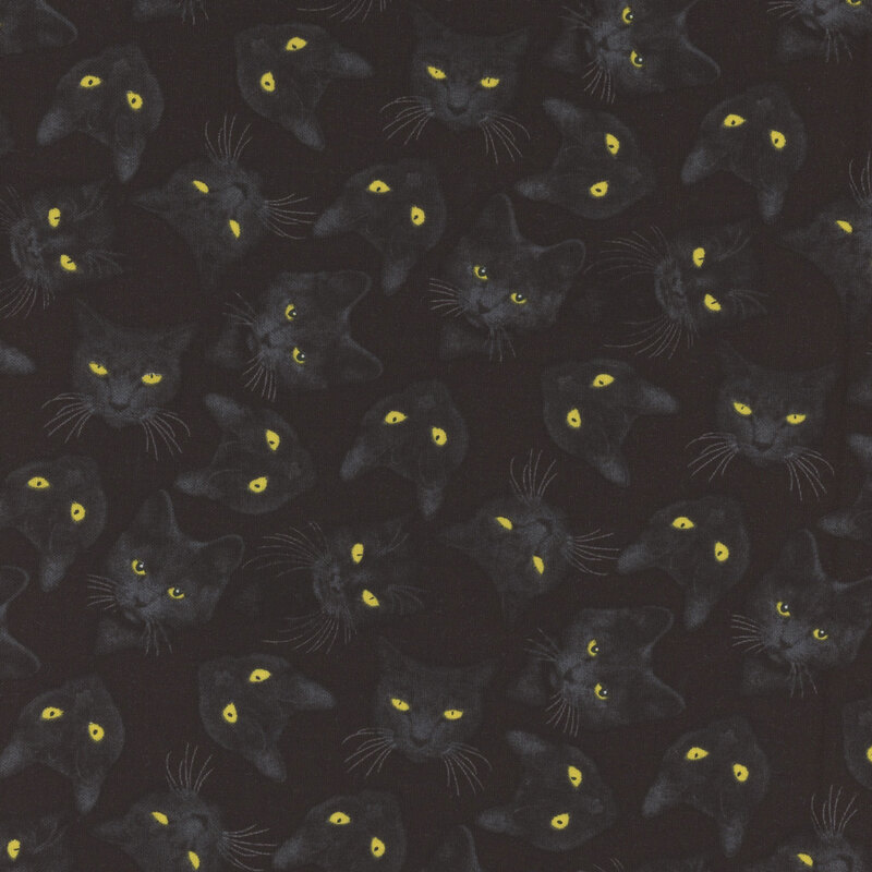 fun black fabric featuring scattered black cat heads with golden eyes