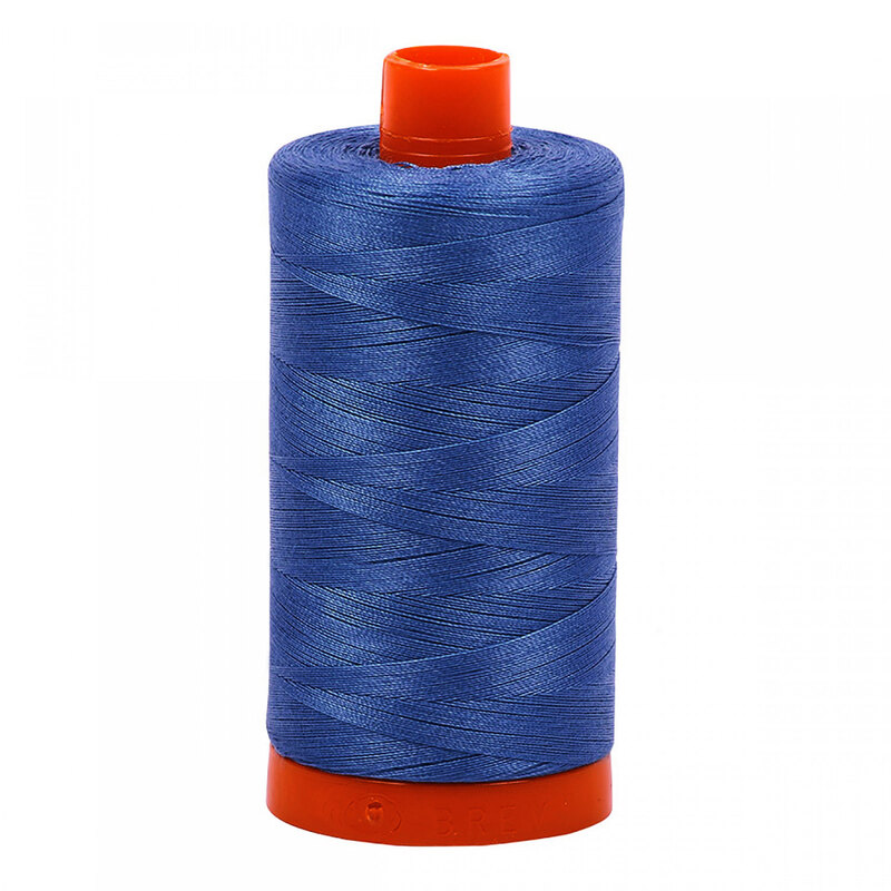 A spool of Aurifil 4140 - Wedgewood thread on a white background
