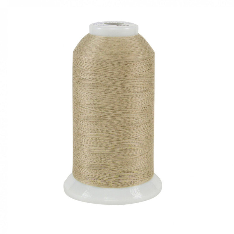 Spool of light taupe So Fine! thread on a white background