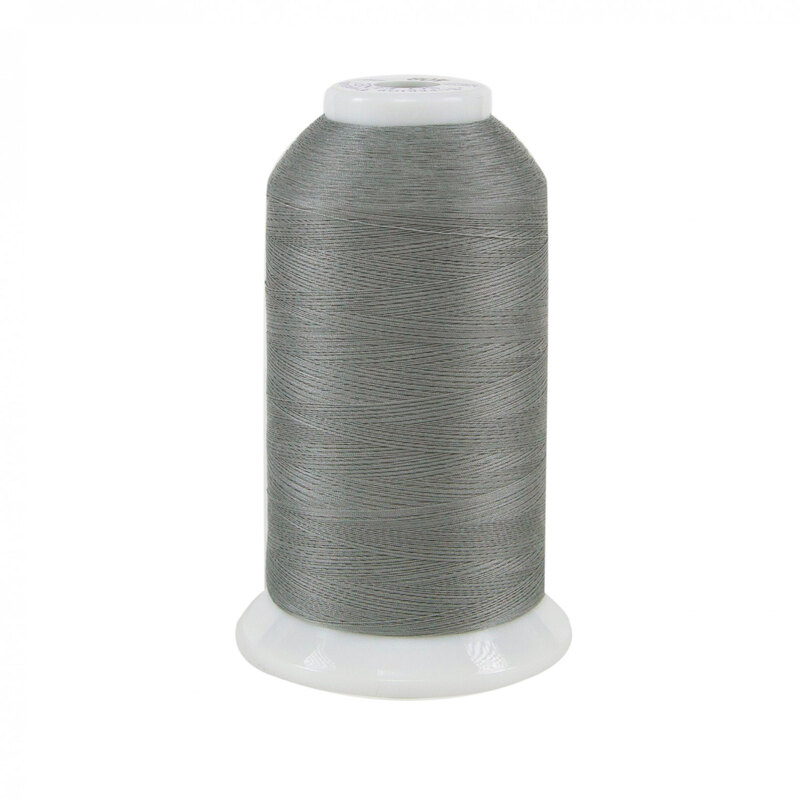 Spool of light gray So Fine! thread on a white background