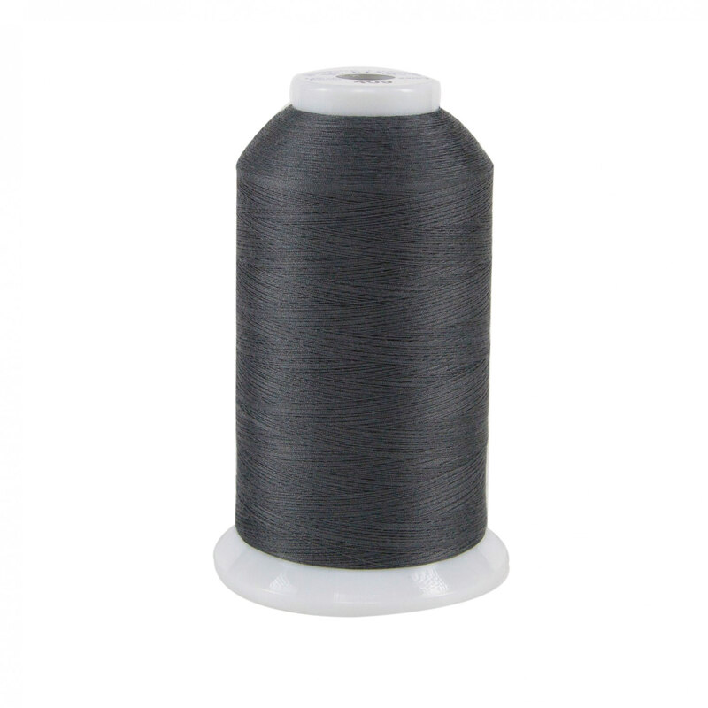 Spool of gray So Fine! thread on a white background